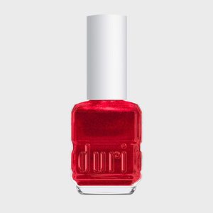 Red nail polish bottle stands vertically with 