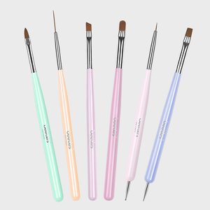 Various pastel-colored nail art brushes are lined up against a plain background.