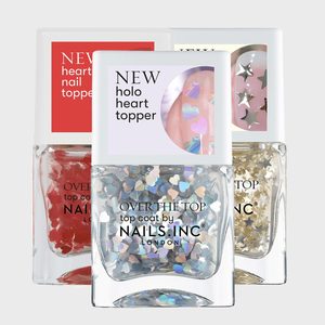 Nail polish bottles display colorful heart-shaped glitter toppers against a plain background, labeled 