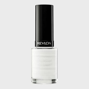 A bottle of white nail polish stands upright; 