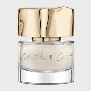 A glass bottle with a distorted gold cap sits against a plain background, labeled 