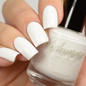 White-painted nails hold a bottle labeled 