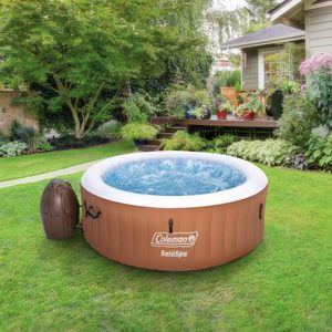 Inflatable hot tub bubbles in a lush garden, surrounded by green grass and various potted plants. Text: 