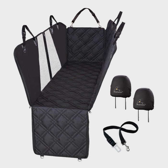 Car seat cover forms a protective hammock with adjustable straps, quilted surface, and side flaps. Includes two headrest covers and a seatbelt tether.