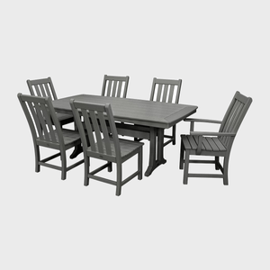 Gray wooden dining set stands still, comprised of a rectangular table and six matching chairs, against a plain white background.