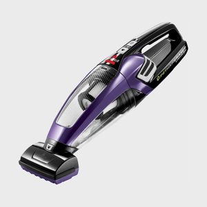 Handheld vacuum cleaner facing right, with a purple and black design, set on a plain white background.