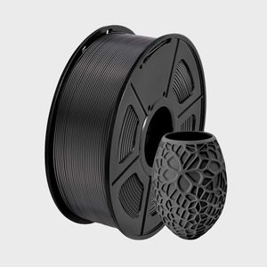 Black filament reel stands upright beside a decorative 3D-printed vase on a plain gray background.