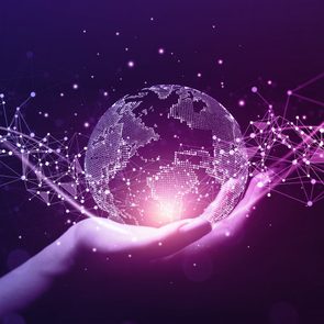 A digital globe hovers over a hand, surrounded by glowing purple network lines in a dark environment.