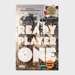 A book cover features a man climbing stacked trailers in a futuristic, industrial setting with the title 