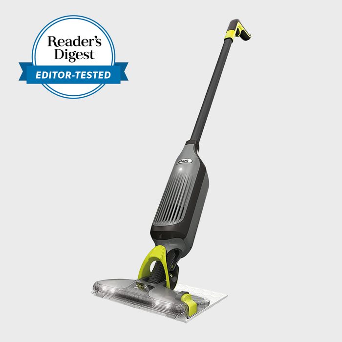 Vacuum cleaner standing upright on a light gray background; labeled 