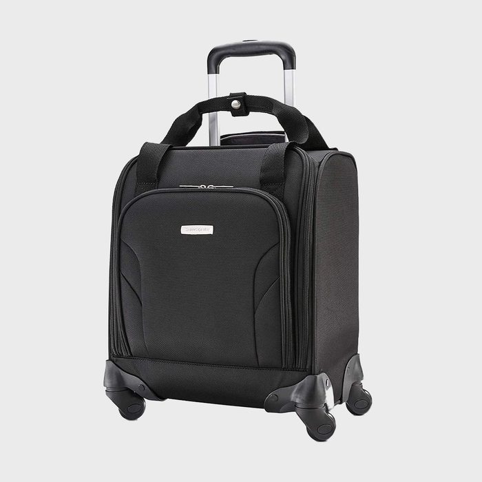 A black carry-on suitcase with four wheels and a retractable handle stands upright against a plain background.