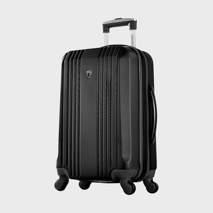A black suitcase stands upright, featuring four wheels and a retractable handle, set against a plain white background.