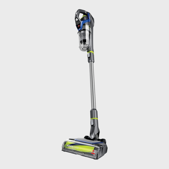 Cordless vacuum cleaner stands upright, showcasing a sleek design, with a transparent dustbin and flexible handle, on a plain gray background.