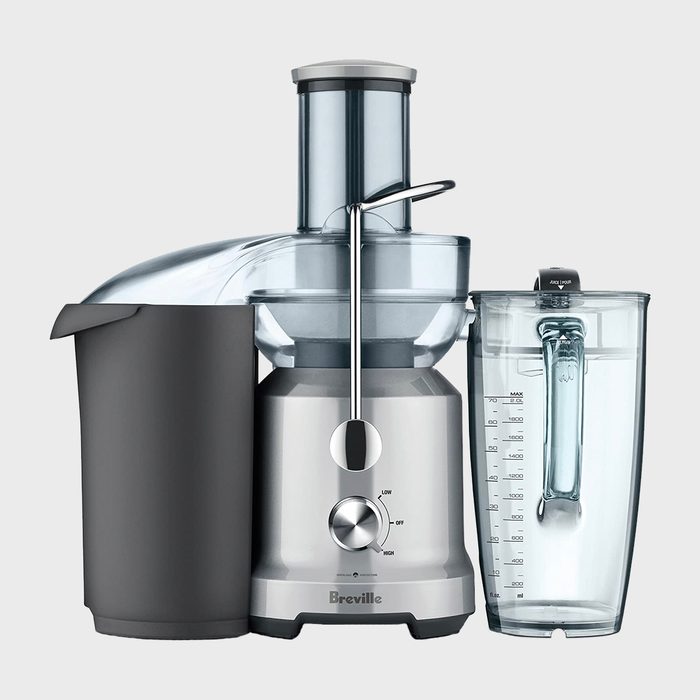Juicer positioned on a white background, featuring a sleek design with a dial for settings and a transparent container for collecting juice.