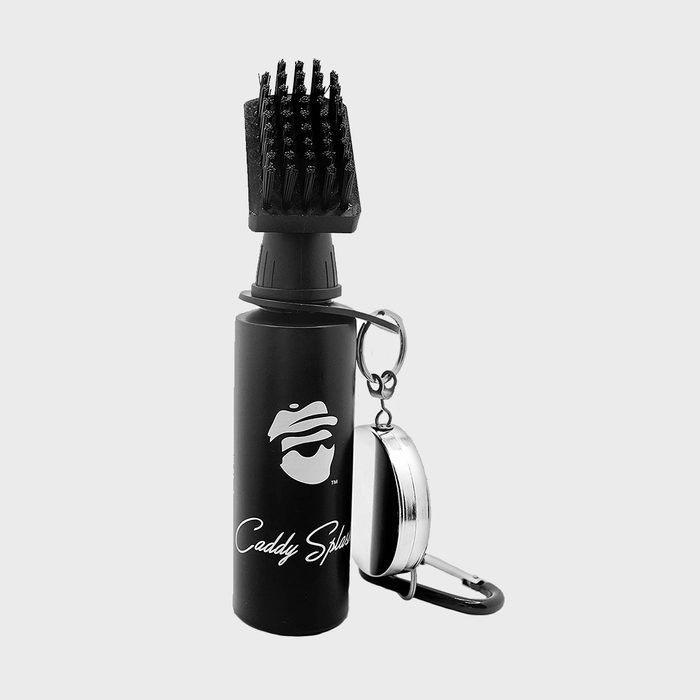 Brush-tipped bottle with carabiner attached, standing against a plain background. The text reads 