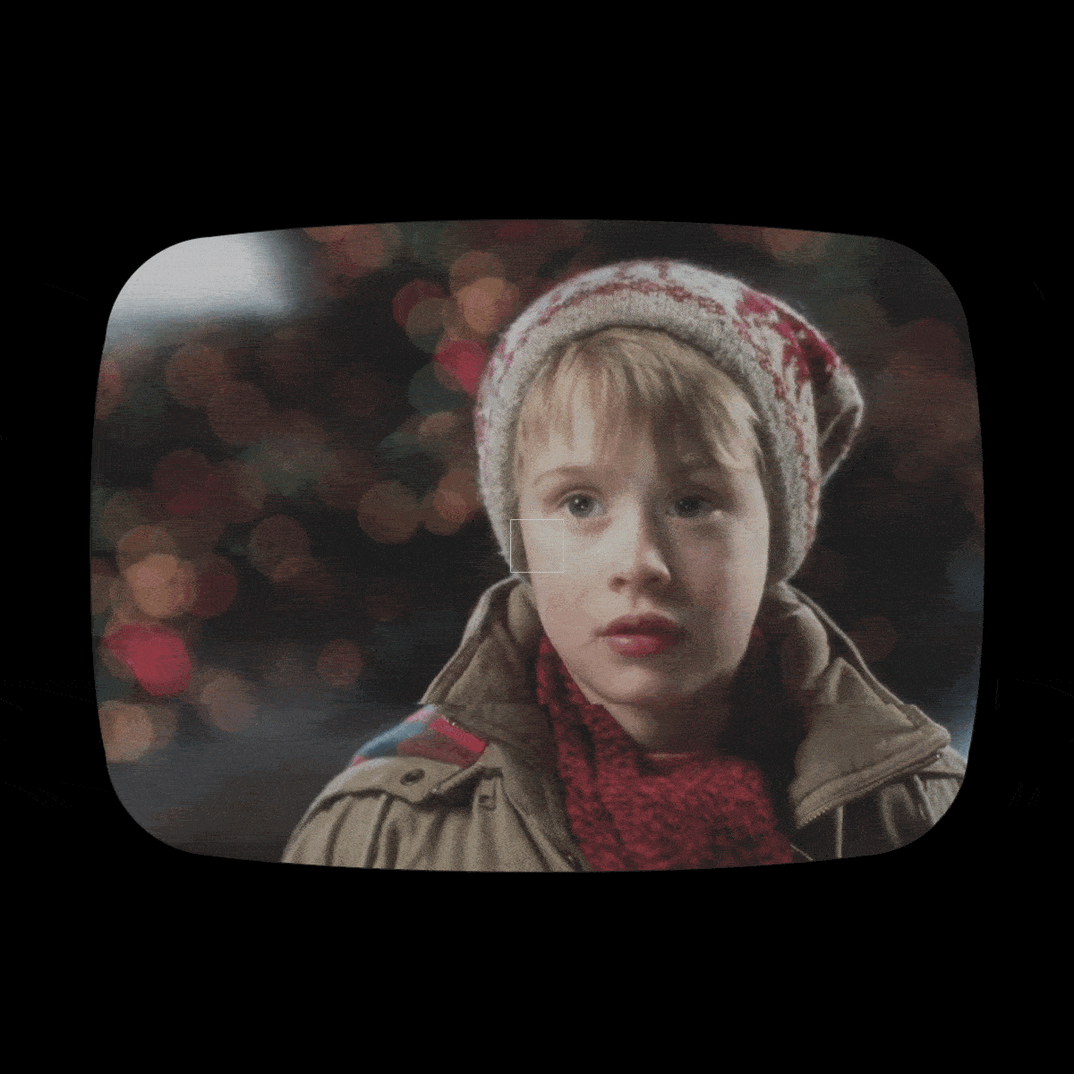 Child stares intently, wearing winter clothing, against a bokeh background of colored lights, framed in a retro TV screen.