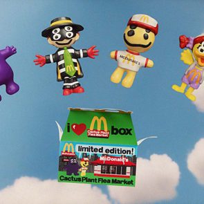 Toys featuring McDonald's characters float against a cloudy sky backdrop. A green Cactus Plant Flea Market box is below, labeled 