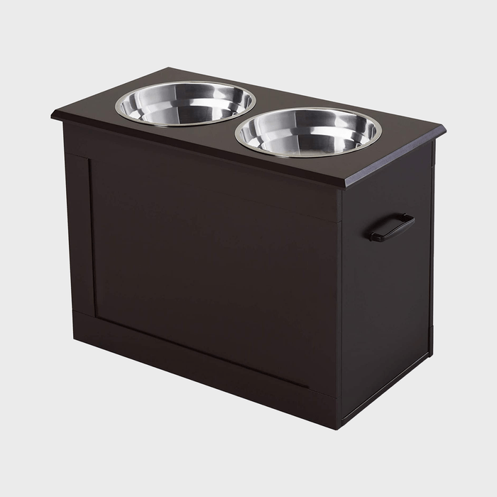 Two metallic bowls sit on a dark wood stand with side handles, set against a plain background.