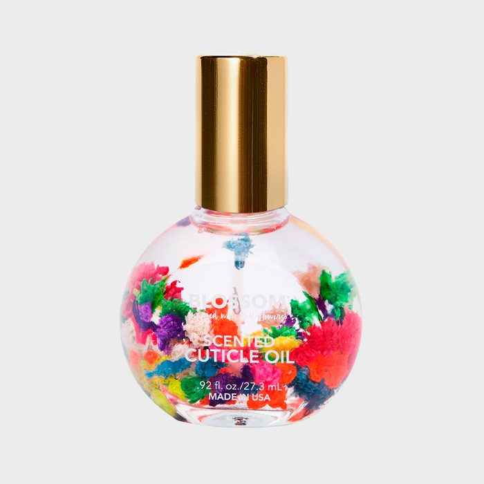 Bottle containing colorful dried flowers sits against a plain background, labeled 