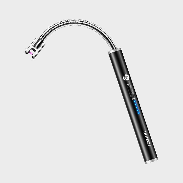 A black electronic lighter with flexible neck ignites, showing LED indicators, set against a plain gray background. Text reads 