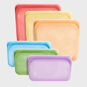 Colorful silicone bags are stacked, showing various sizes and hues, against a plain gray background.