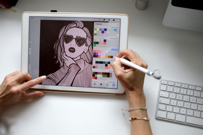 Female web designer using tablet at home