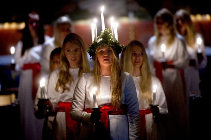 Amanda Lindblom (C) performs as Santa Lu