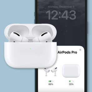 AirPods sit in open case, displayed over smartphone showing battery status at 66% and 35%, time 12:43, and date Monday, December 5.