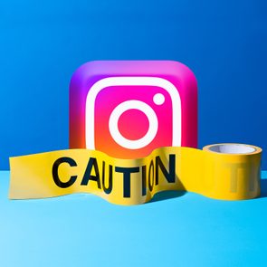 Instagram logo behind yellow caution tape, set against a blue background.