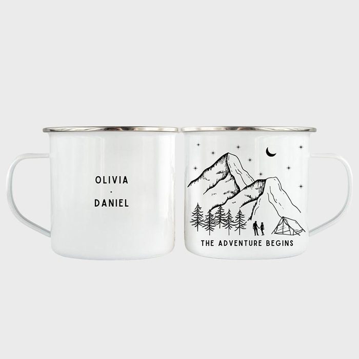 Two white mugs display text, 