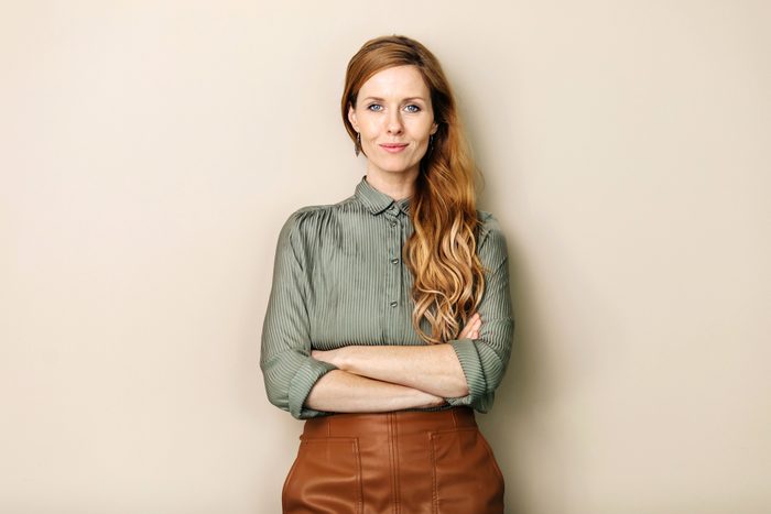 Businesswoman Smiling With Arms Folded
