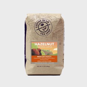 Coffee bag displays hazelnut-flavored medium roast, featuring illustrated hazelnuts, with 