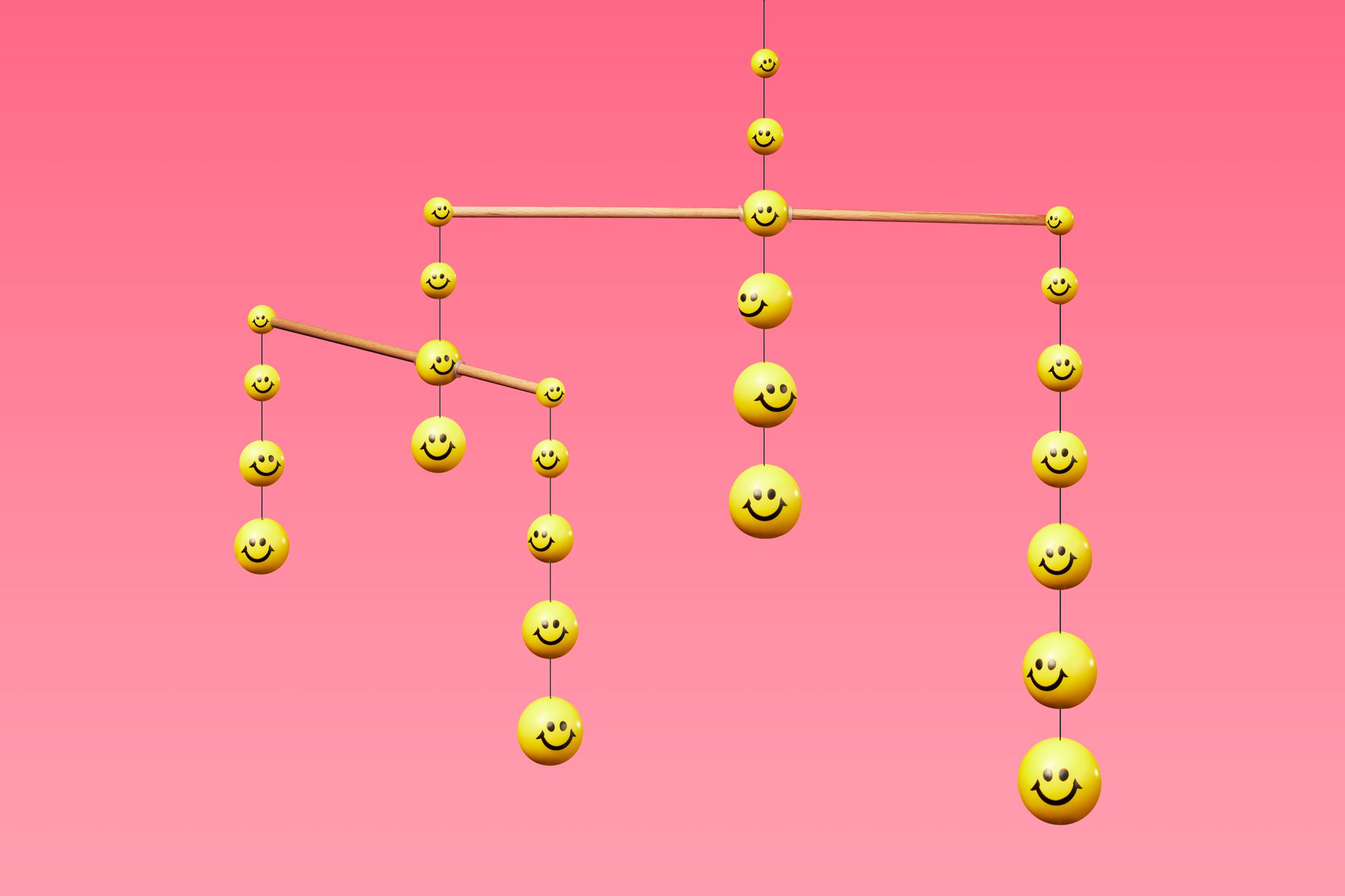 mobile made up of yellow smiley faces on pink background to represent community and support network for a happier life