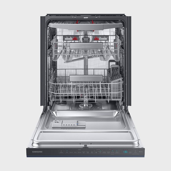 Open dishwasher displaying empty racks and control panel in a stainless steel interior.