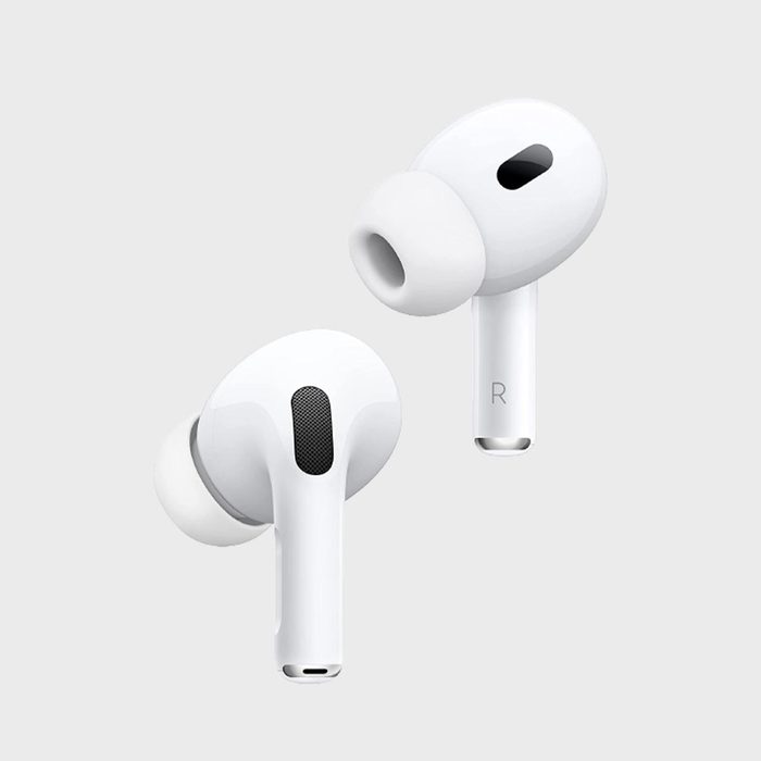White wireless earbuds floating, showcasing sleek design against a light gray background. 