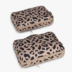 Two leopard print fabric pouches lie flat against a plain white background, each featuring a zipper and small black label.