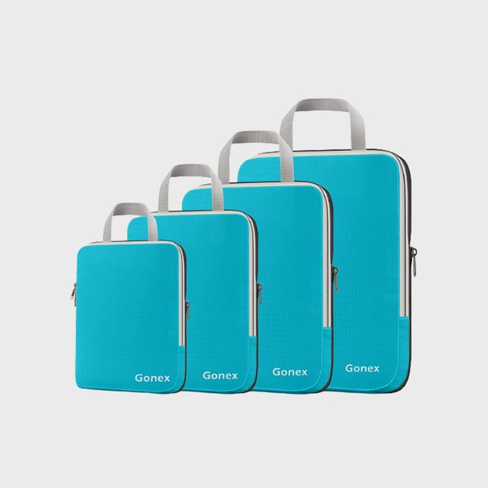 Four blue zippered pouches stand, each progressively larger, labeled 