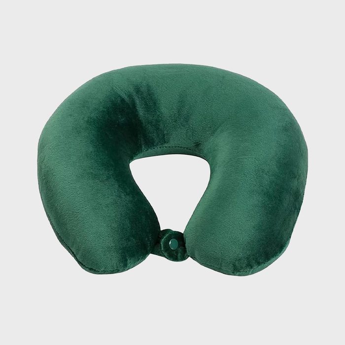 Green neck pillow lying flat against a plain light gray background.