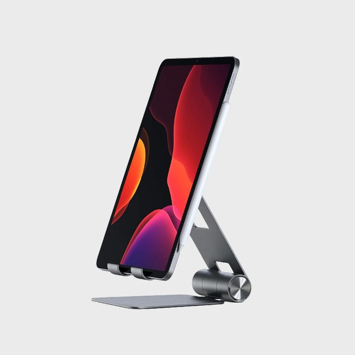 Tablet stands on a sleek, adjustable metal stand against a plain gray background.