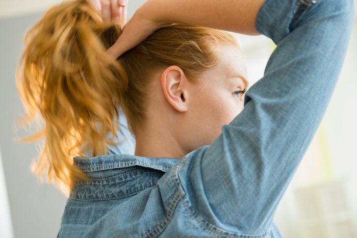 woman putting in pony tail