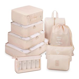Beige travel packing cubes arranged neatly; includes drawstring and zippered bags. Text reads 