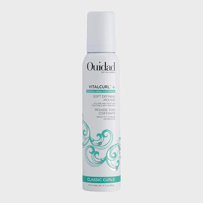 A tall, cylindrical mousse bottle labeled 