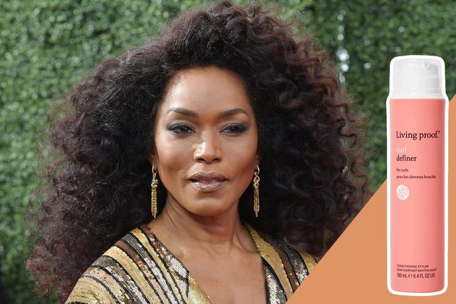 A woman with curly hair poses outdoors; a 