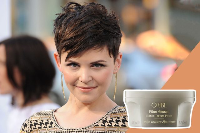 Person smiles, wearing patterned top and gold earrings, in a blurred outdoor setting. Text includes 