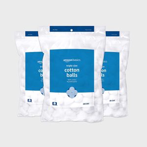 Three bags containing white cotton balls are displayed against a plain background. Text reads: 