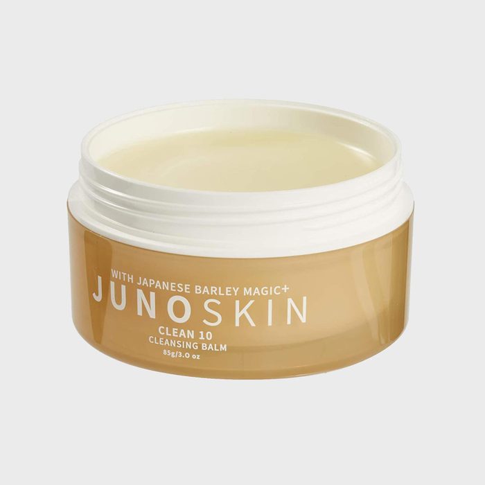 Open jar holding creamy cleansing balm; labeled 