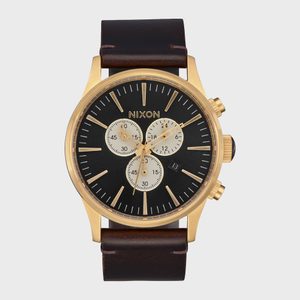 Gold watch with black face, displaying time, date, and stopwatch dials. 