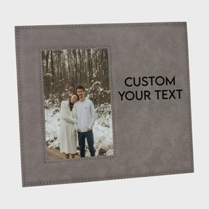 Photo frame displaying smiling couple in snowy forest, with 