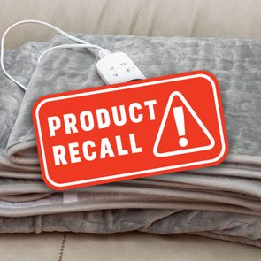Electric blanket with attached controller on sofa; red 