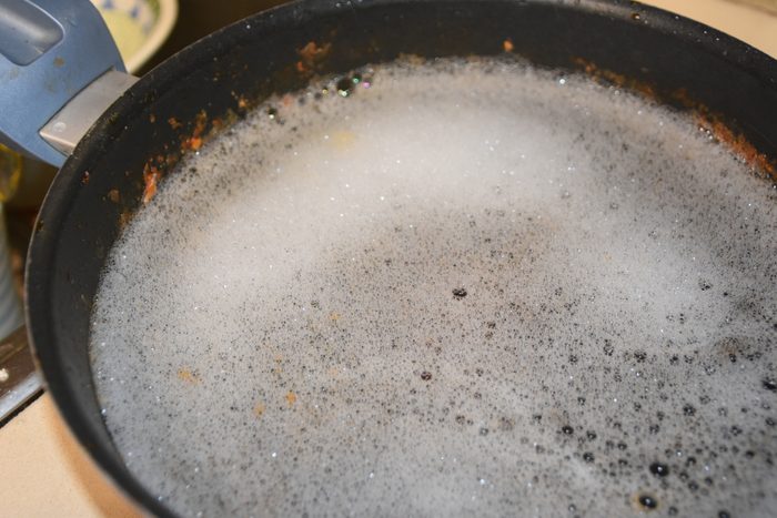 Soaking pot in water and soap